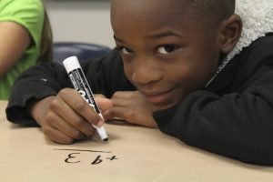 Young child practising mathematics